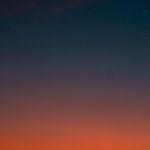 Fiery sunset with crescent moon Crescent moon and fiery orange sunset horizon